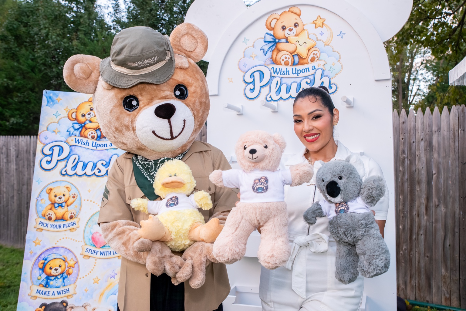 Ingrid Herrera with the Wish Upon a Plush bear mascot and plush friends